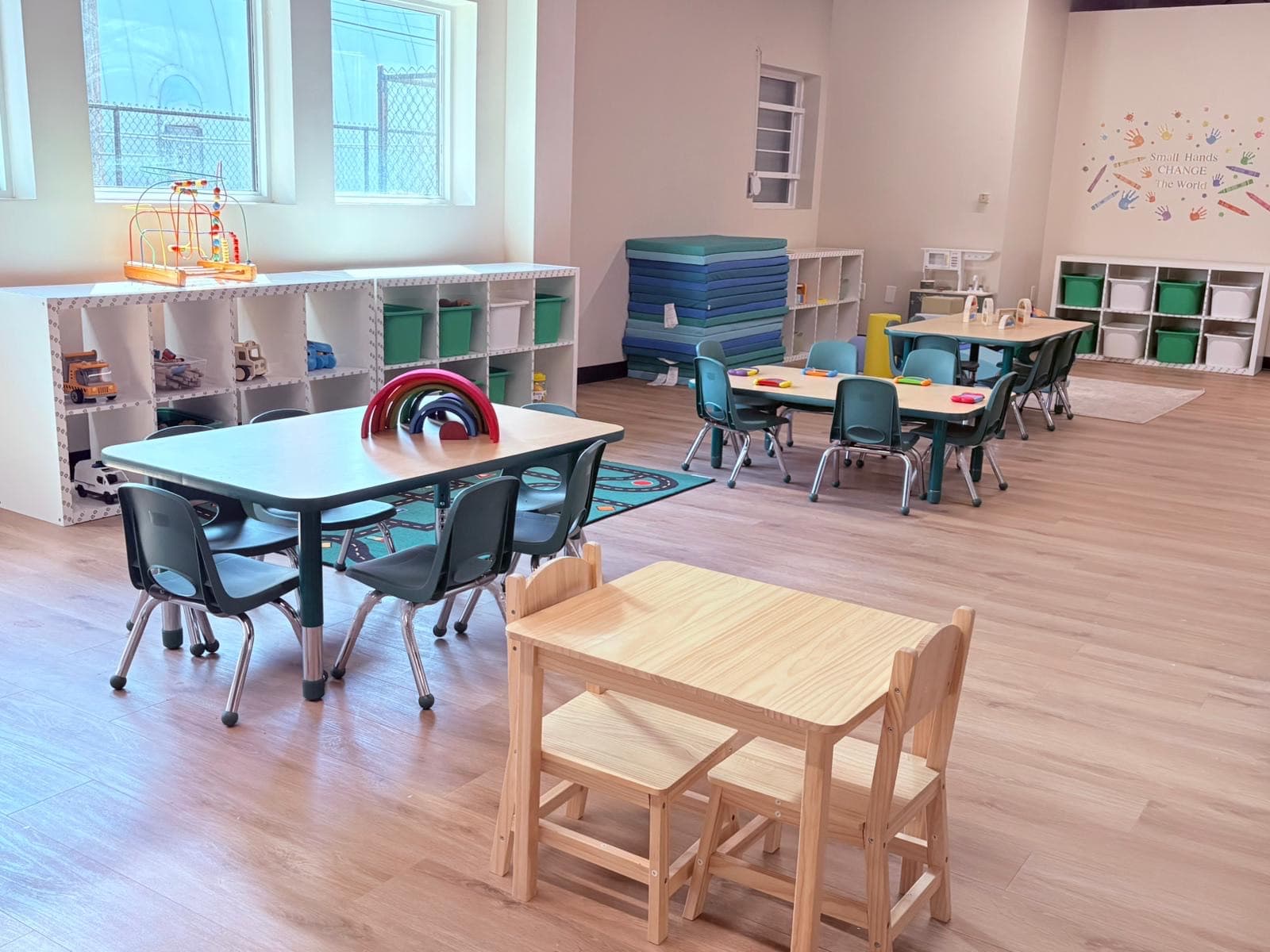 Dramatic play and literacy shelves stocked with toys and books